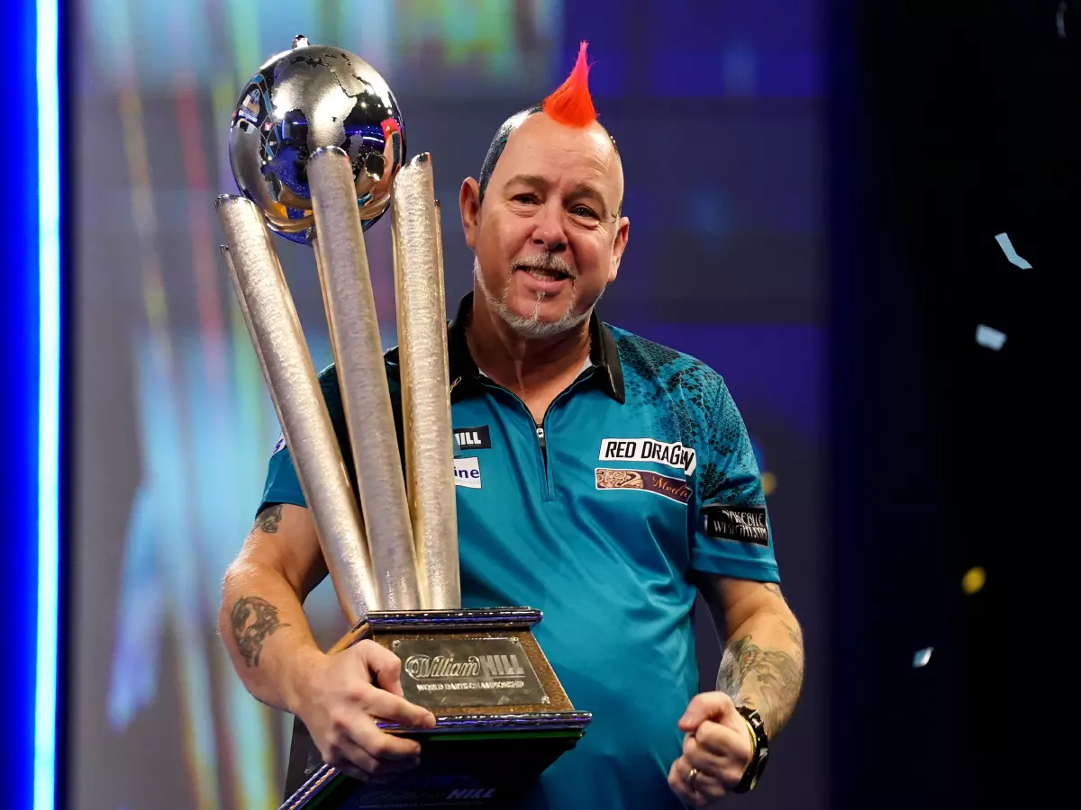 Peter Wright with the Sid Waddell Trophy after victory against Michael Smith during day sixteen of the William Hill World Darts Championship at Alexandra Palace, London. Picture date: Monday