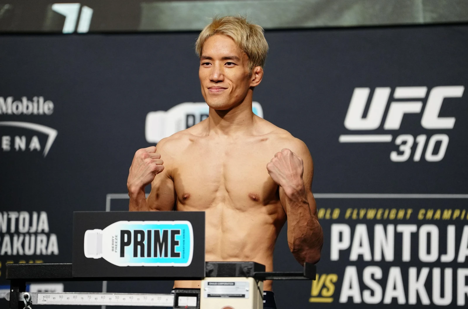 Kai Asakura steps on the scale for the official weigh-ins for UFC 310