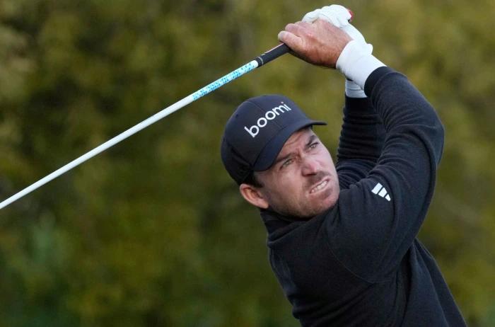 Nick Taylor, of Canada, watches his tee shot on the fifth hole during the third round of the Phoenix Open