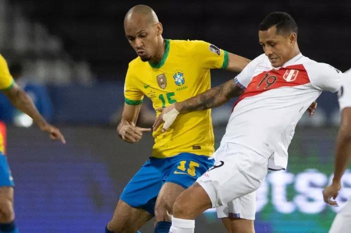 Fabinho wrestles for the ball against Peru in Group B