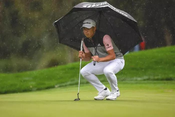 Collin Morikawa takes shelter at the 2022 PLAYERS Championship