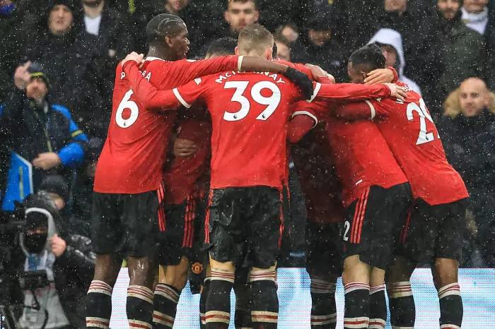 Manchester United players celebrate their win vs Leeds United