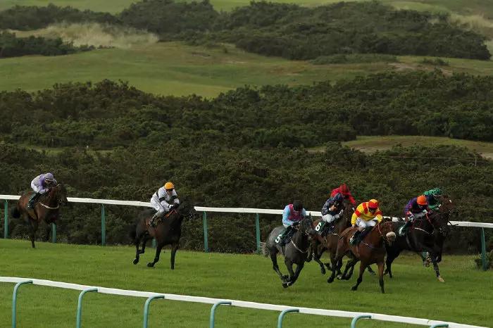 Thundering Home ridden by jockey Matthew Davies (No. 5) comes through to win the digibet Handicap Stakes on day one of the July Meeting at Great Yarmouth Racecourse