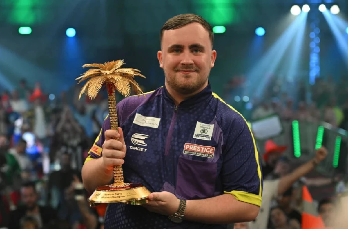 Luke Littler with the Bahrain Darts Masters trophy
