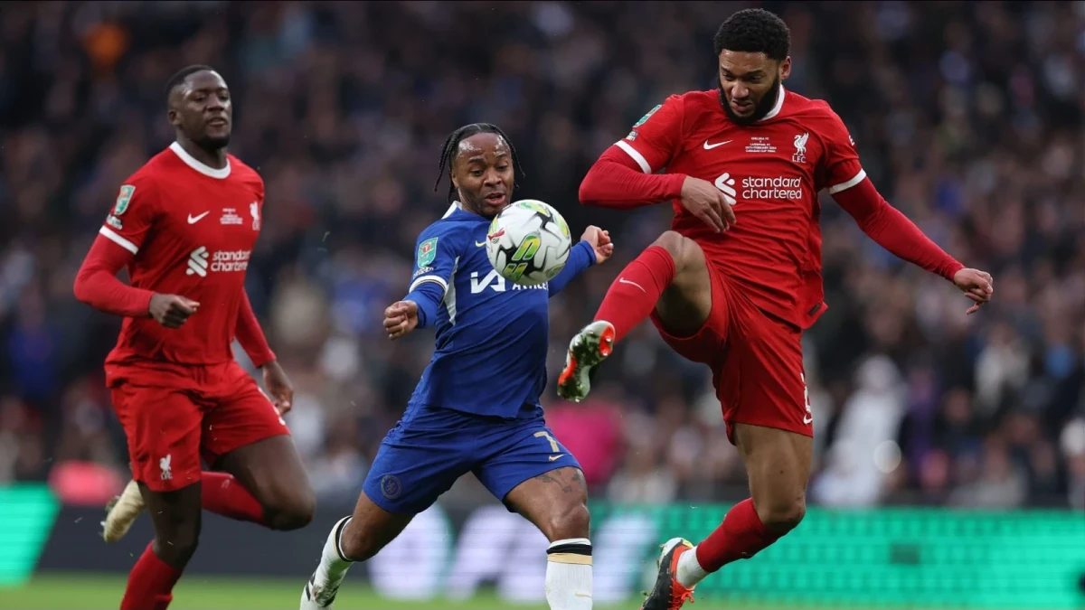 Raheem Sterling of Chelsea is challenged by Joe Gomez of Liverpool