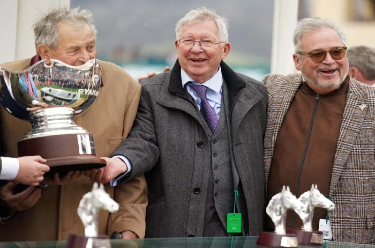 Sir Alex Ferguson, owner of Protektorat, celebrates winning the Ryanair Steeple Chase