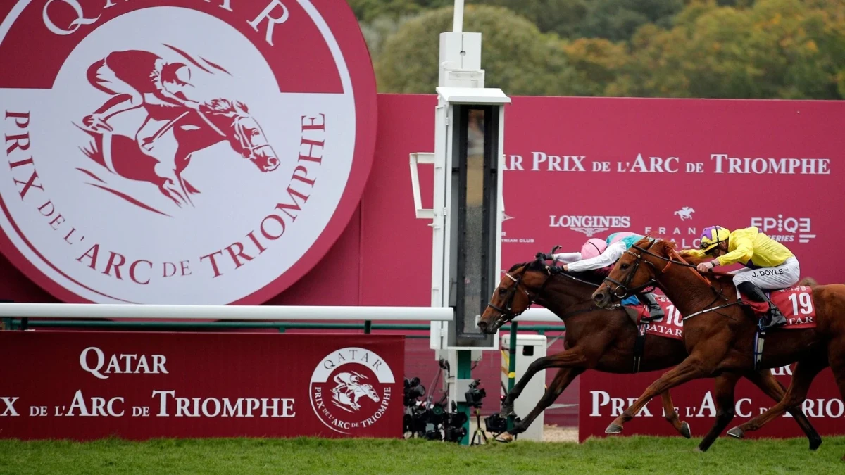 Italian Lanfranco Dettori riding British horse Enable, left, ahead of JW Doyle riding Irish horse Sea of Class, right, crosses the finish line to win the Qatar Prix de l'Arc de Triomphe horse