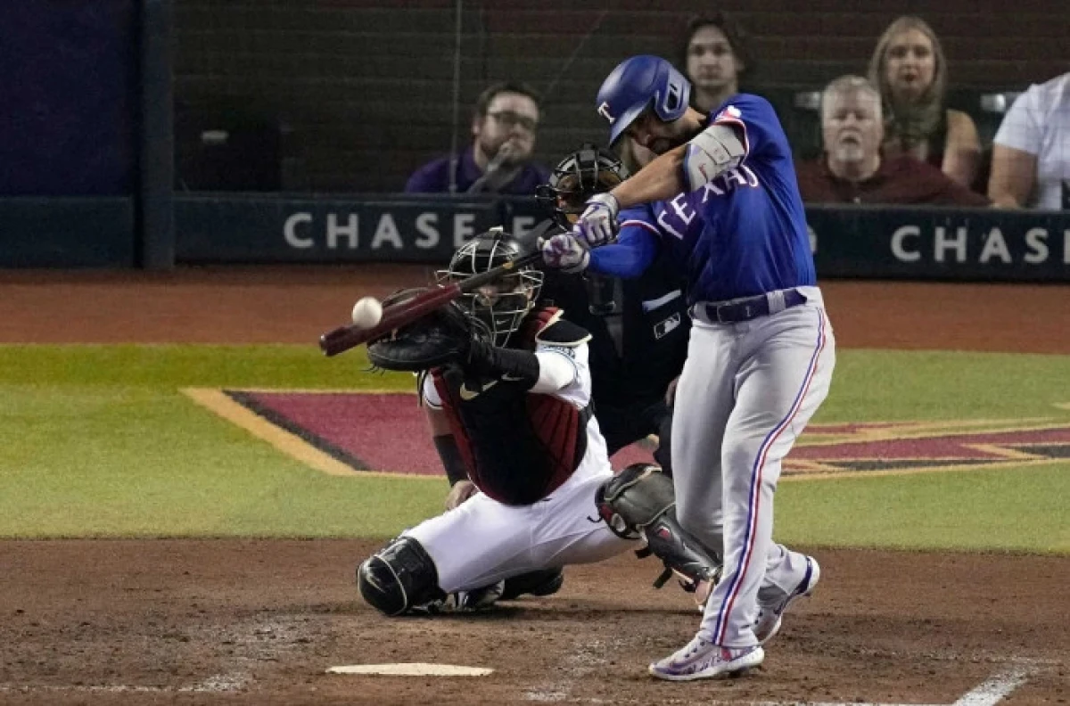 Texas Rangers Marcus Semien (right) hits a two-run home run against the Arizona Diamondbacks in the MLB World Series - Nov 2023