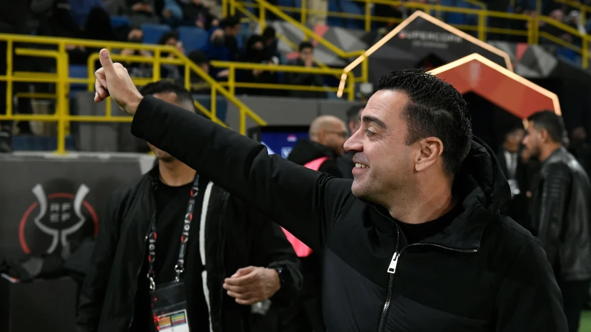 Barcelona's head coach Xavi Hernandez greets fans