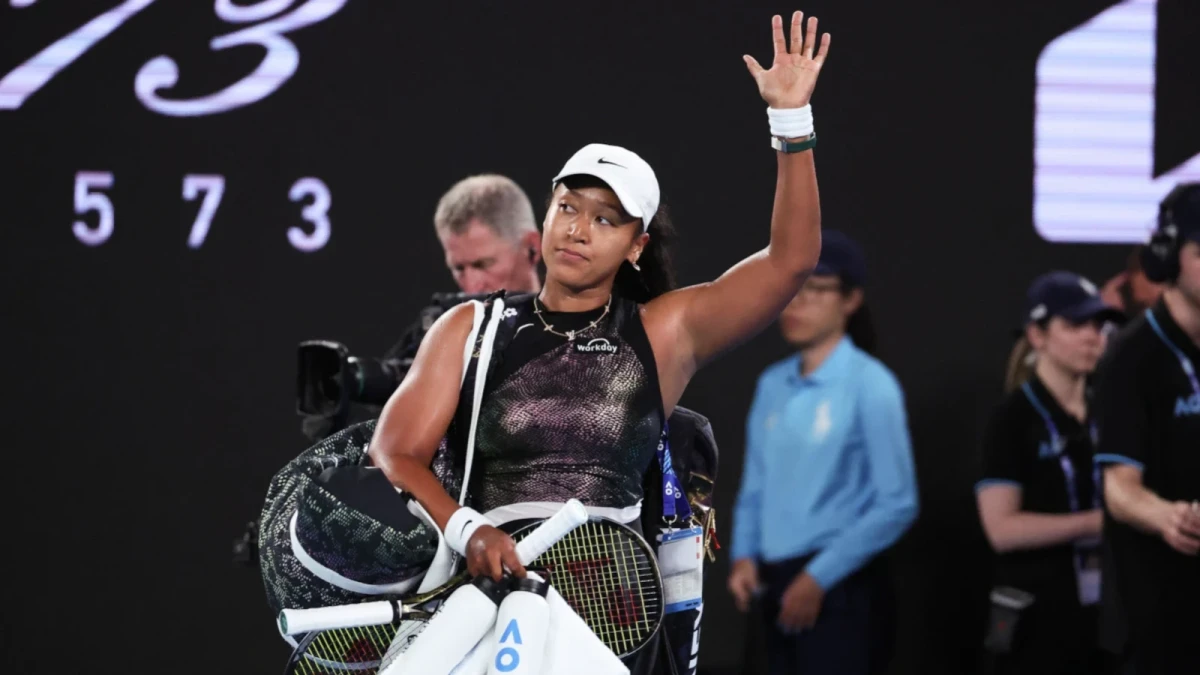 Naomi Osaka waves to fans at the Australian Open