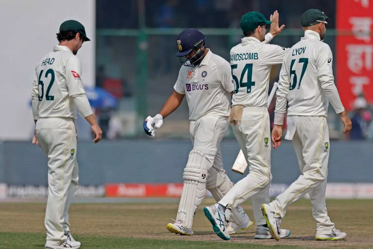 Australia's Nathan Lyon and teammates celebrate the wicket of India's Rohit Sharma - March 2023
