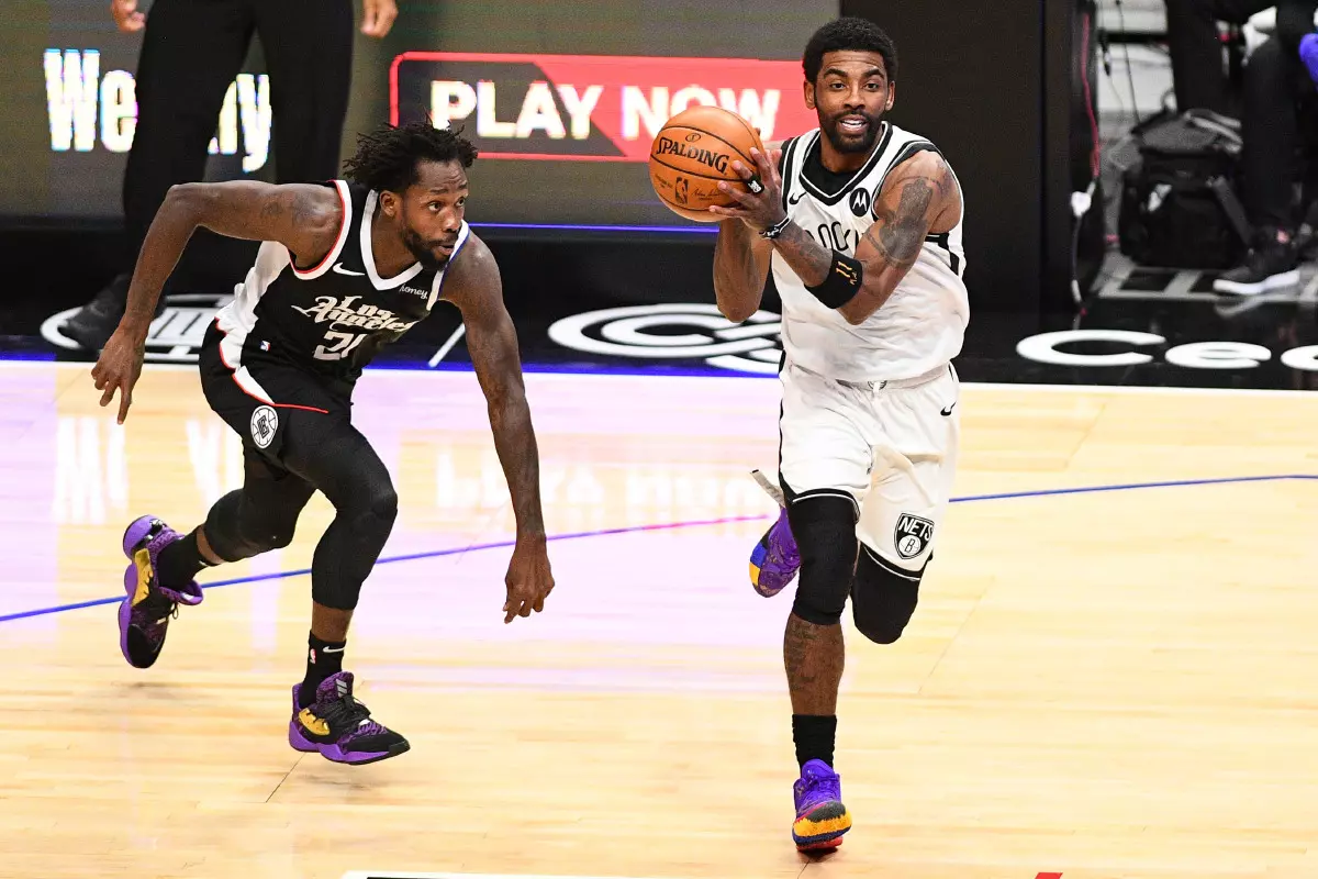 Brooklyn Nets Guard Kyrie Irving (11) make a pass during a NBA game between the Brooklyn Nets and the Los Angeles Clippers on February 21, 2021 at STAPLES Center in Los Angeles, CA.