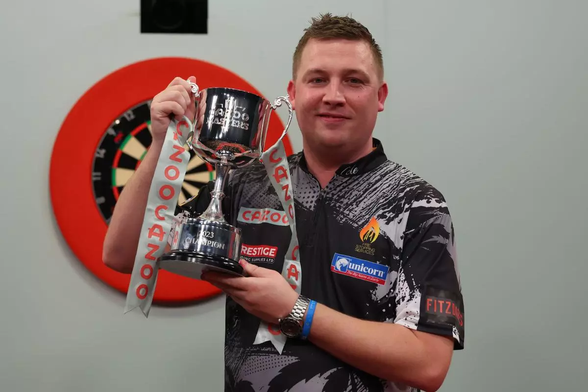 Chris Dobey celebrates with the Cazoo masters trophy