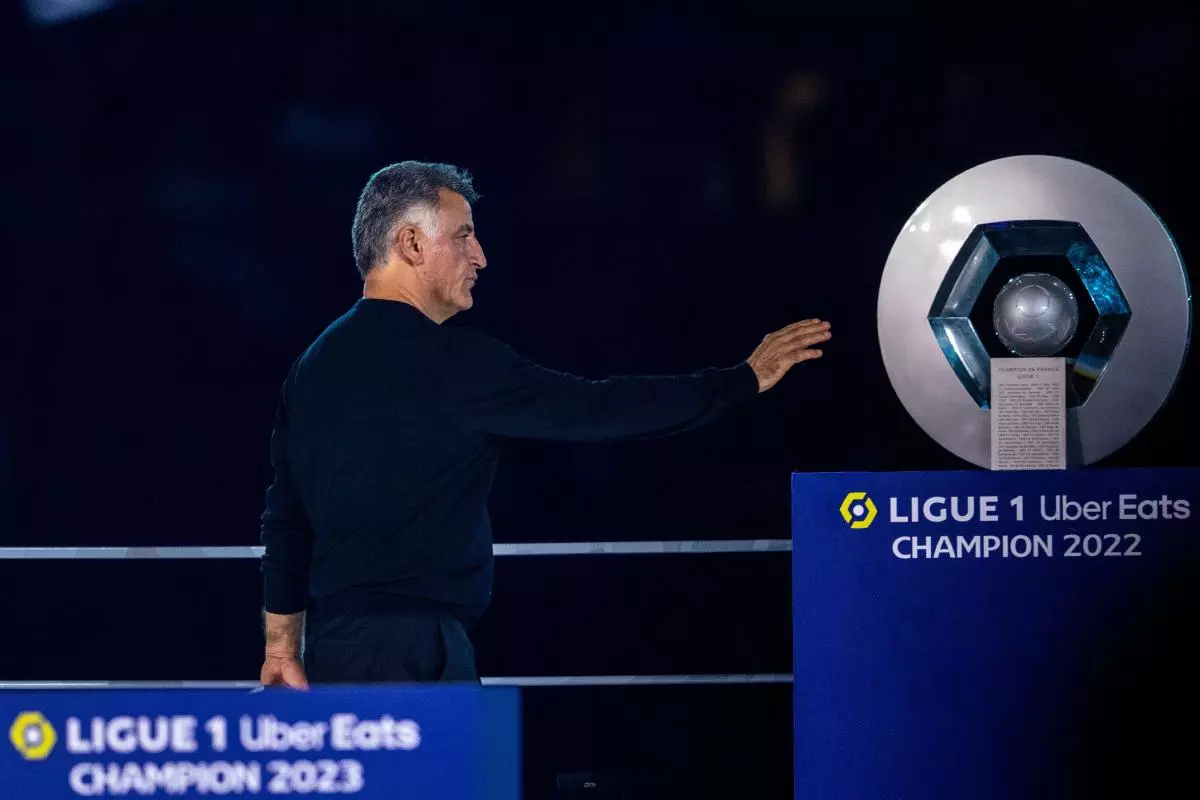 Christophe Galtier of Paris Saint-Germain reaching for the Ligue 1 trophy - June 2023