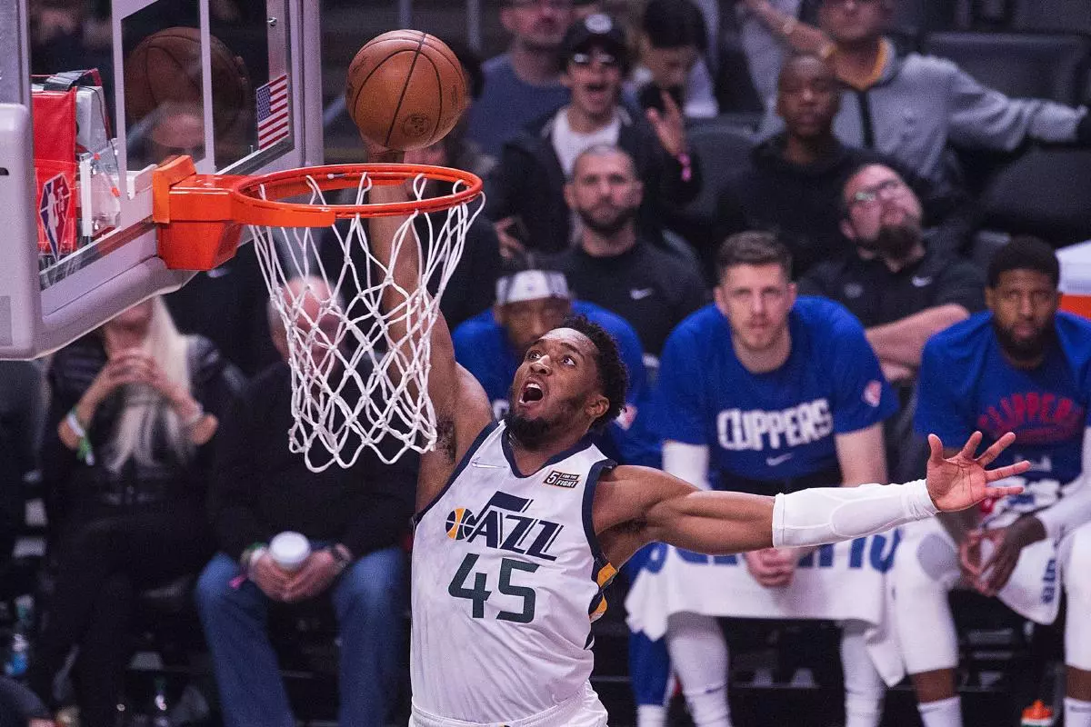 Donovan Mitchell #45 of the Utah Jazz dunks the ball during their NBA game