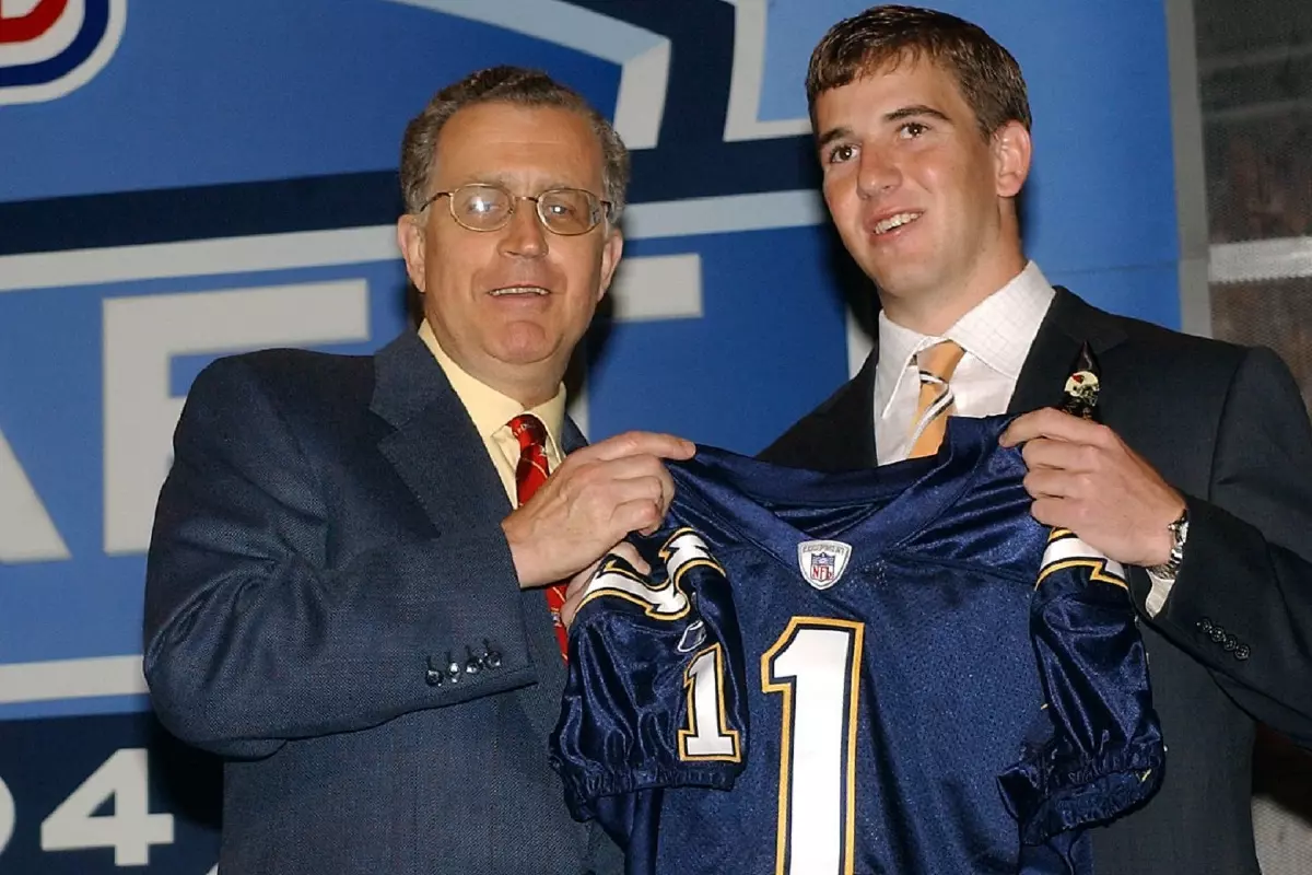 Eli Manning forces a smile when drafted by the Chargers