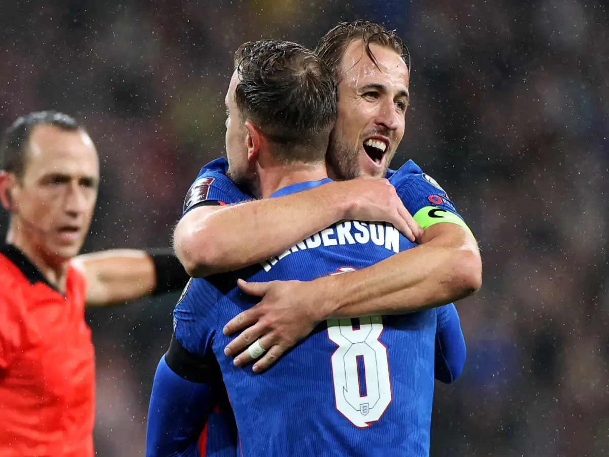 England's Jordan Henderson (front) celebrates scoring with his teammate Harry Kane during the FIFA World Cup Qatar 2022 qualification Group C football match between England and Albania in Lon