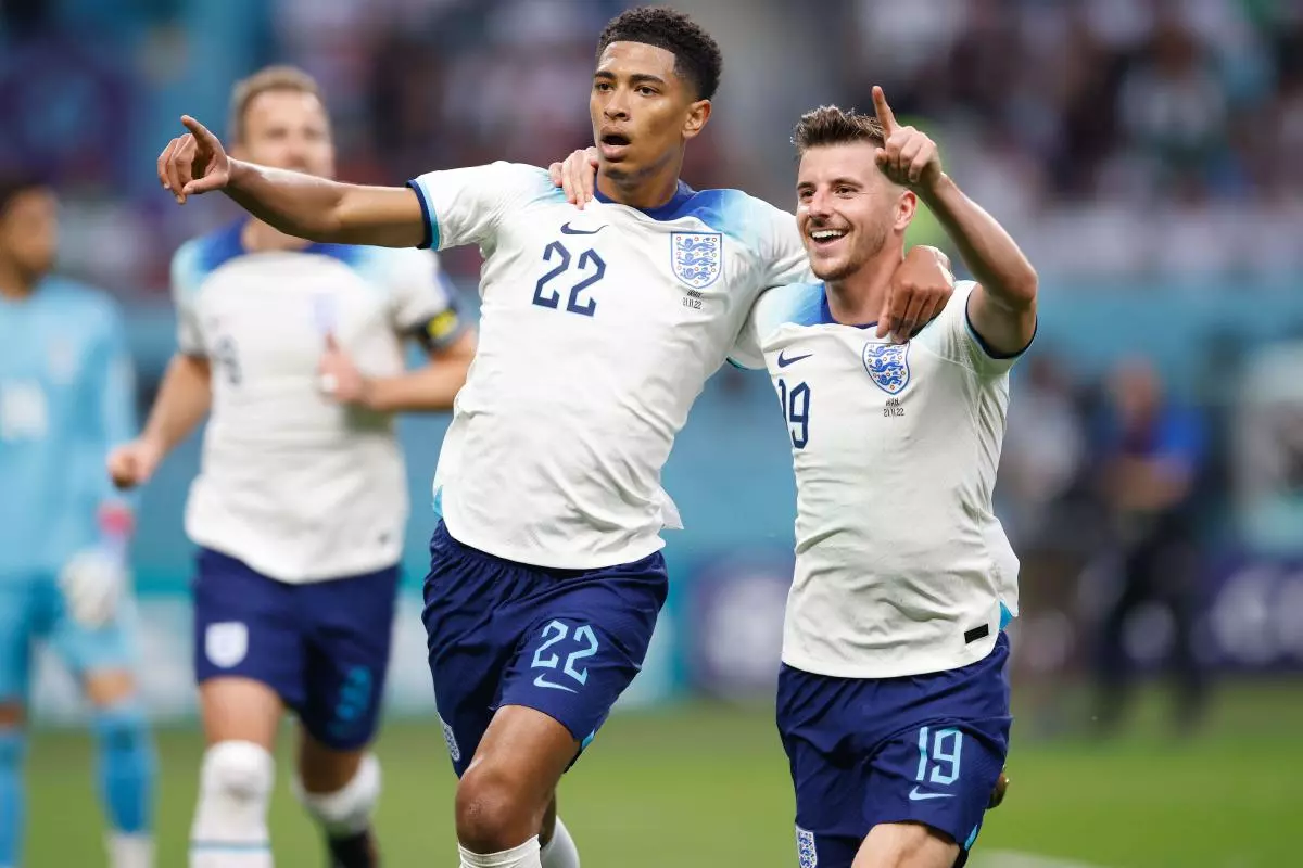 England's Jude Bellingham celebrates scoring v Iran with Mason Mount