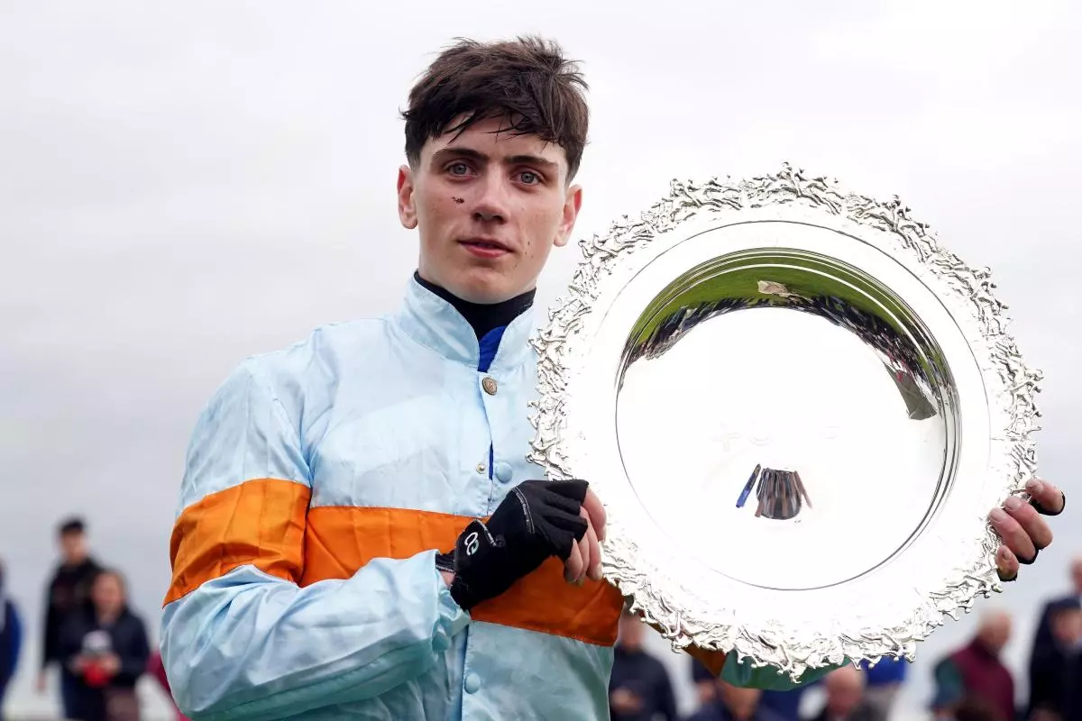 Jockey Danny Gilligan with the plate after winning the Tote Galway Plate