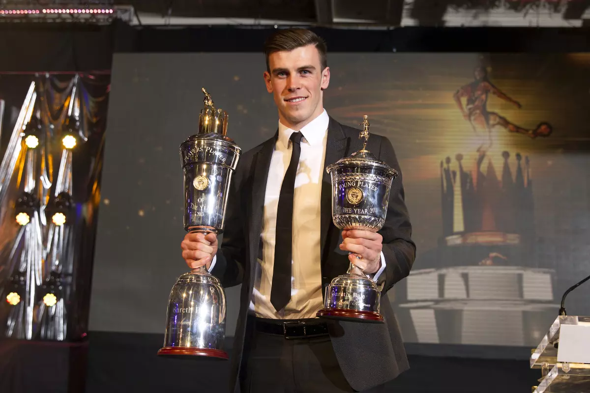 Gareth Bale holds his Young Player of the Year and Players' Player of the Year trophies during the PFA Player of the Year Awards 2013 at the Grosvenor House Hotel, London.
