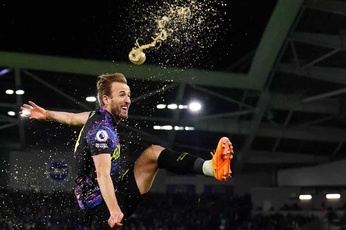 Harry Kane kicks a Coca Cola bottle after scoring vs Brighton