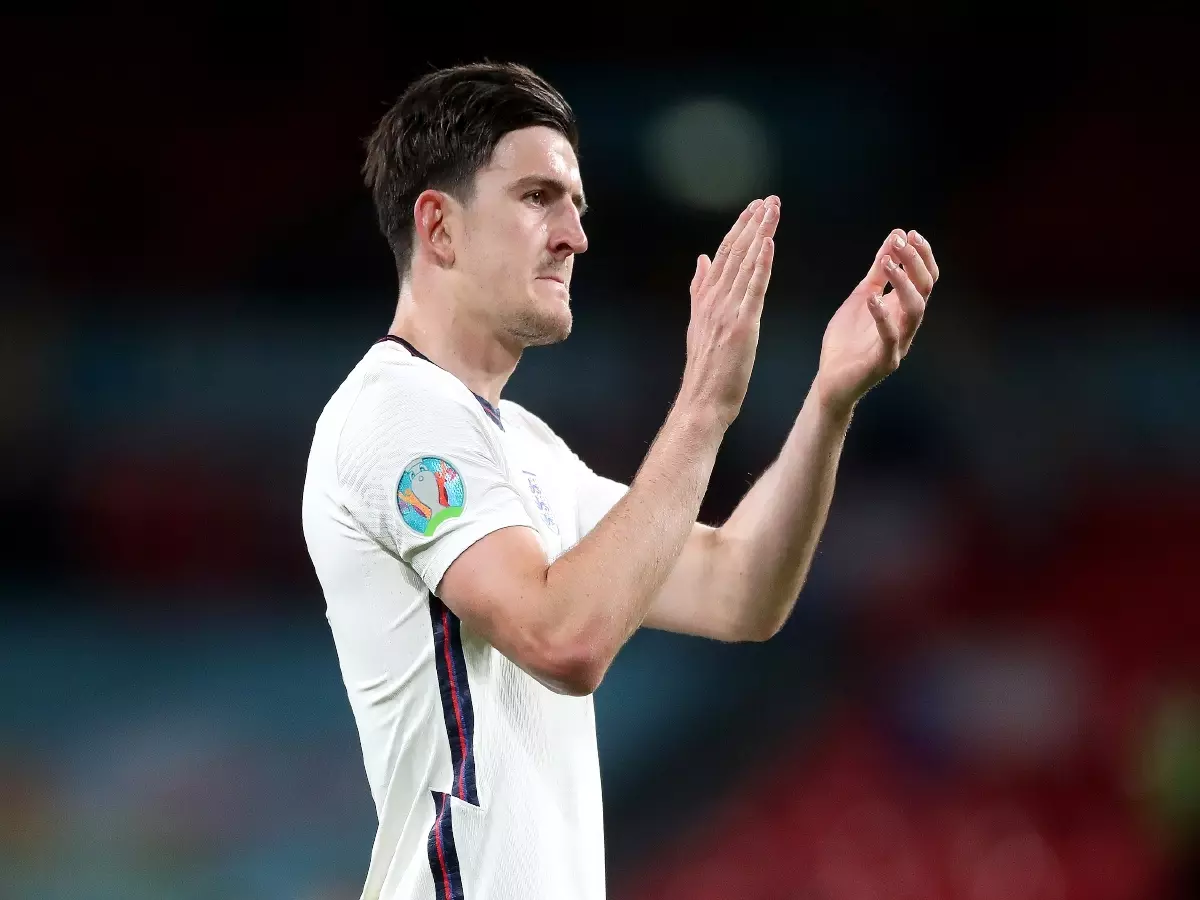 Harry Maguire applauds the England supporters.