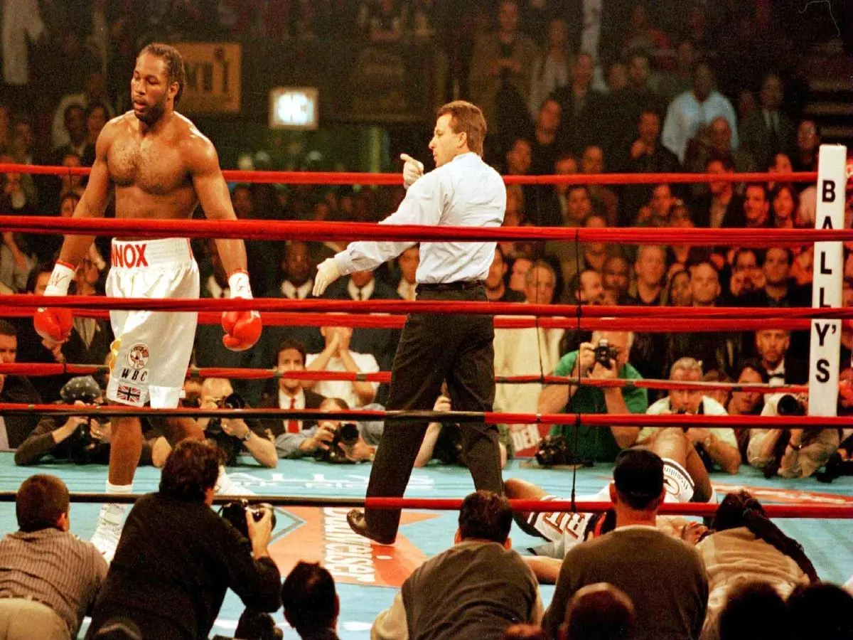 Lennox Lewis walks to corner after Michael Grant is knocked down in the 2nd Round