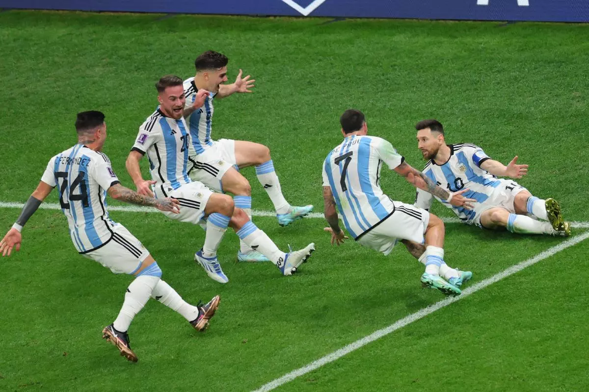 Lionel Messi of Argentina scores a goal from the penalty spot and celebrates with team-mates