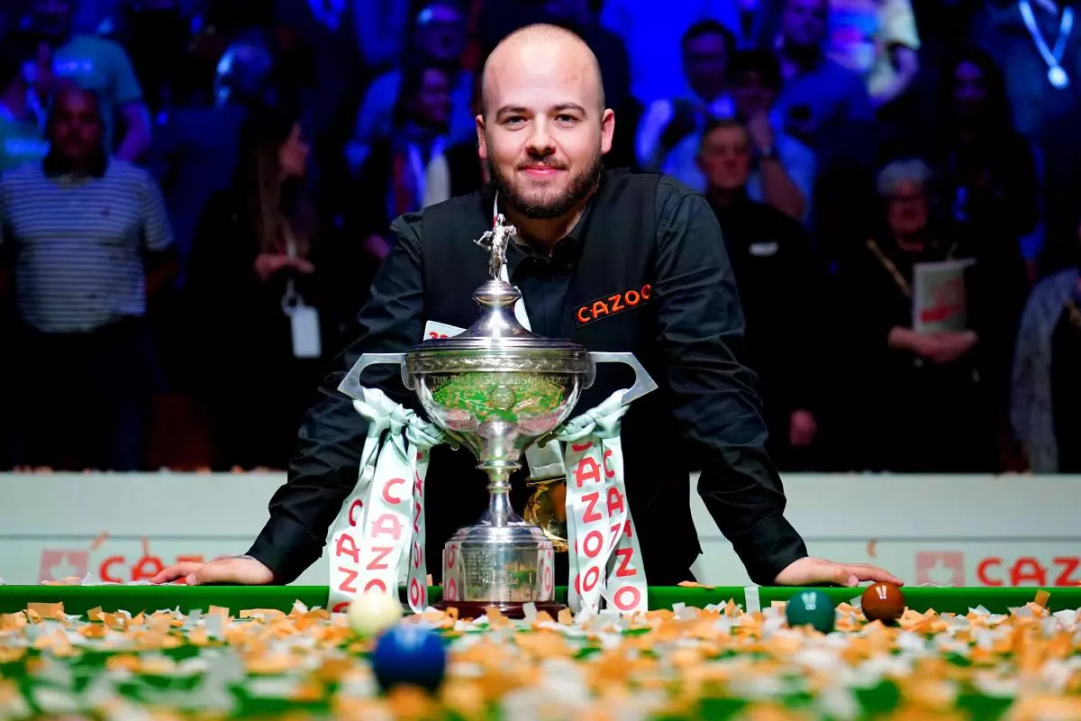 Luca Brecel celebrates with the World Snooker Championship trophy after beating Mark Selby