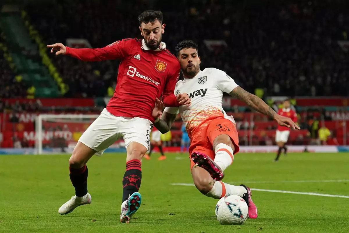 Manchester United's Bruno Fernandes (left) and West Ham United's Emerson Palmieri