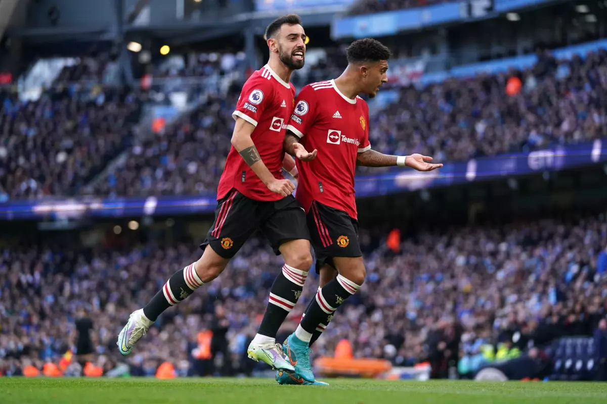 Manchester United's Jadon Sancho (right) celebrates scoring their side's first goal of the game with team-mate Bruno Fernandes during the Premier League match at the Etihad Stadium, Mancheste
