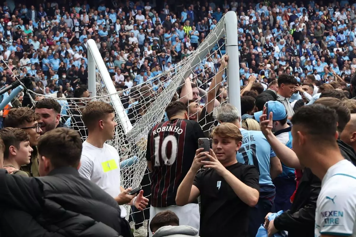 Manchester City fans tear down goal in Etihad pitch invasion