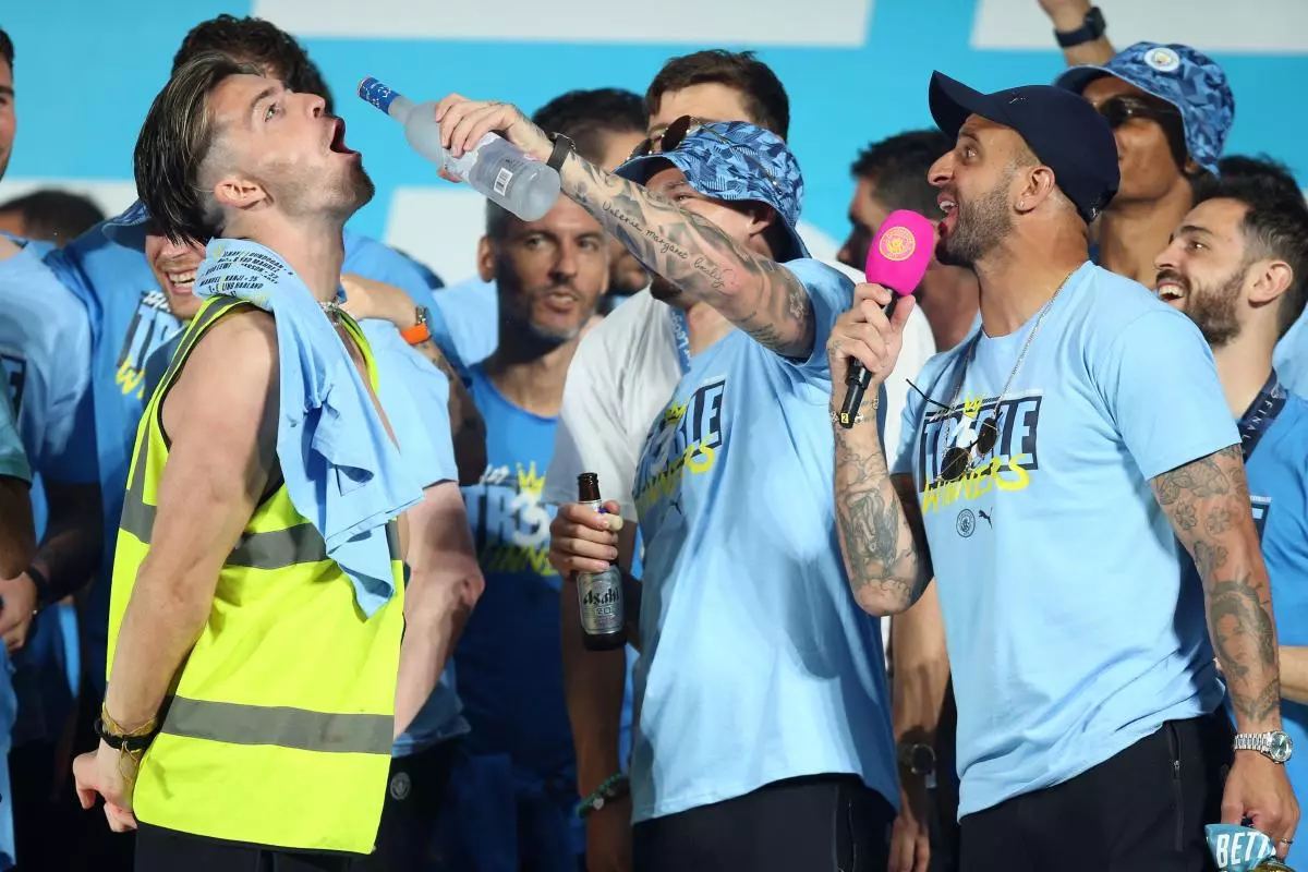 Manchester City's Jack Grealish (left), Kalvin Phillips (centre) and Kyle Walker (right) on stage during the Treble Parade