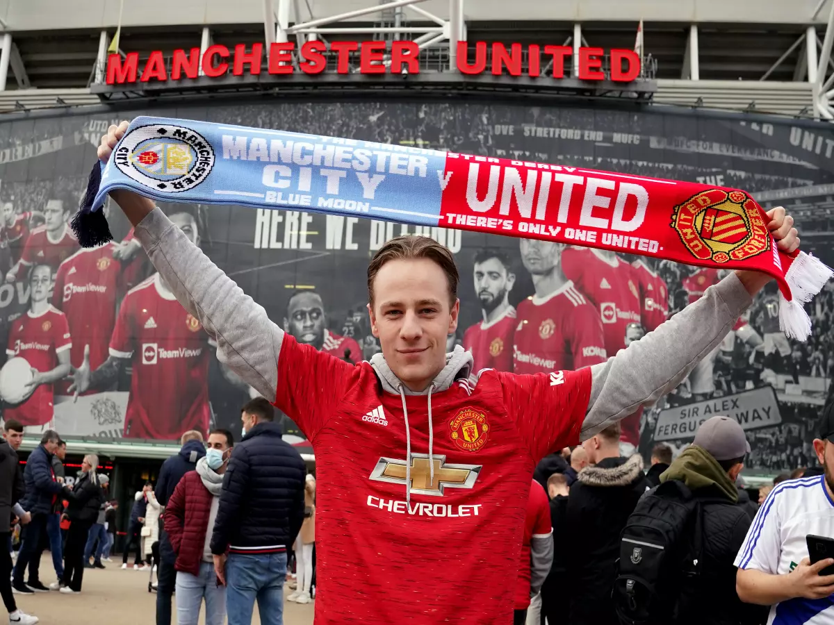 A Manchester United fan ahead of the Premier League match between Manchester United and Manchester City at Old Trafford, Manchester.
