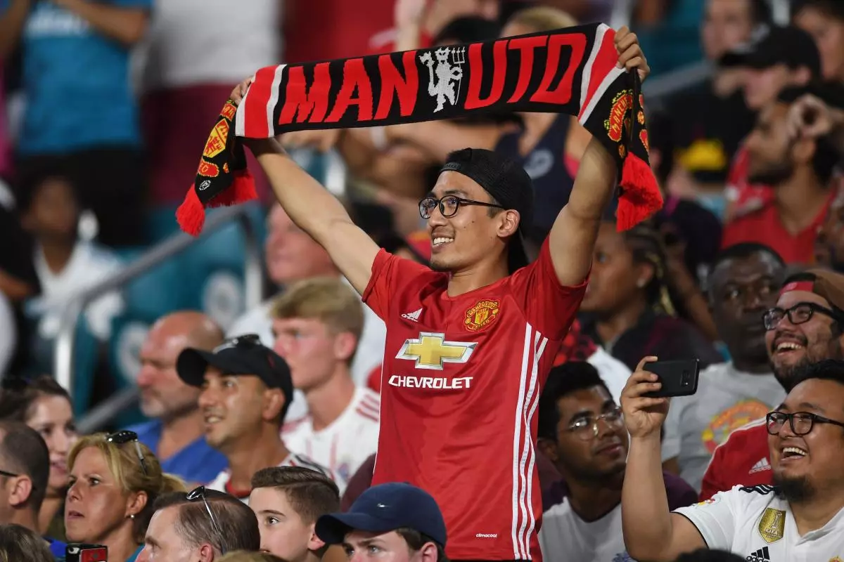 Manchester United fans celebrate a goal