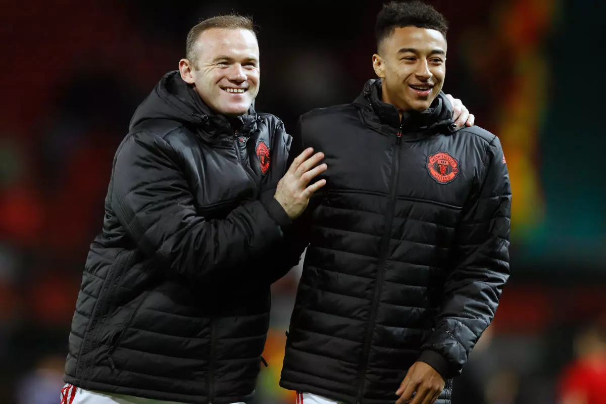 Manchester United's Wayne Rooney (left) shares a joke with Jesse Lingard