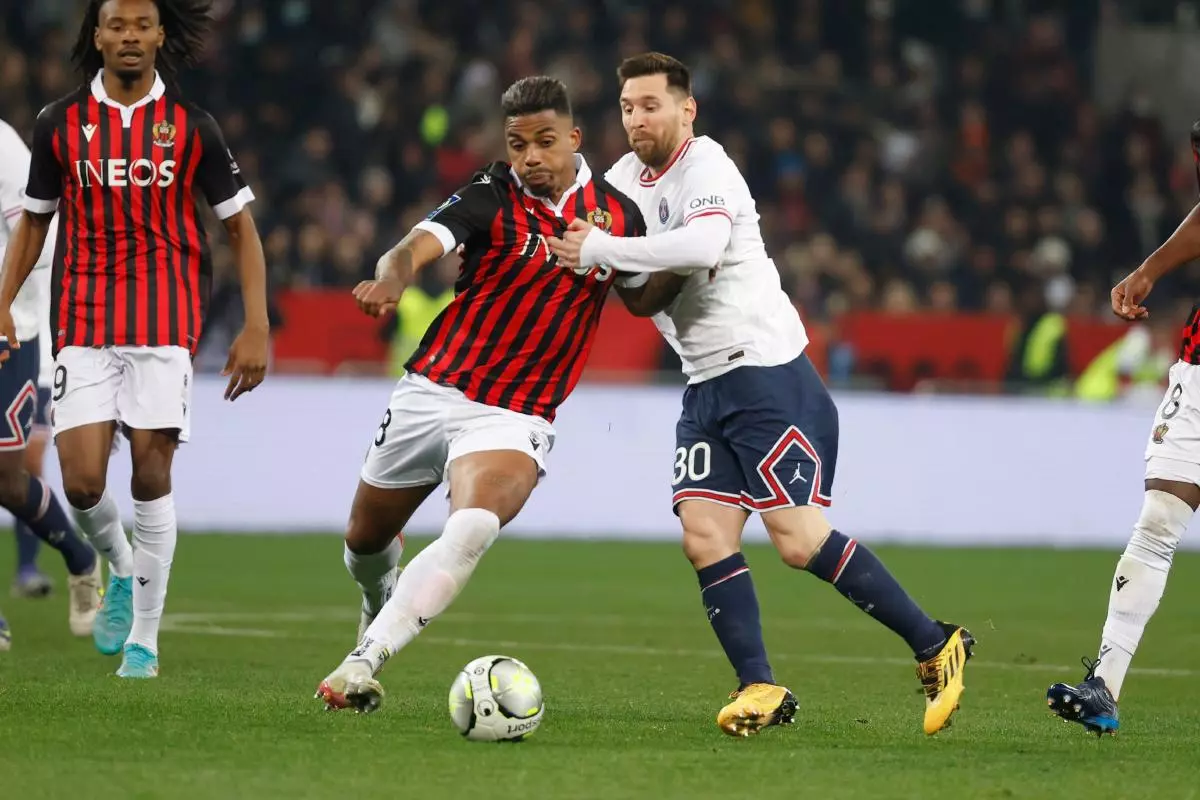 Paris St Germain's Lionel Messi in action with OGC Nice's Mario Lemina