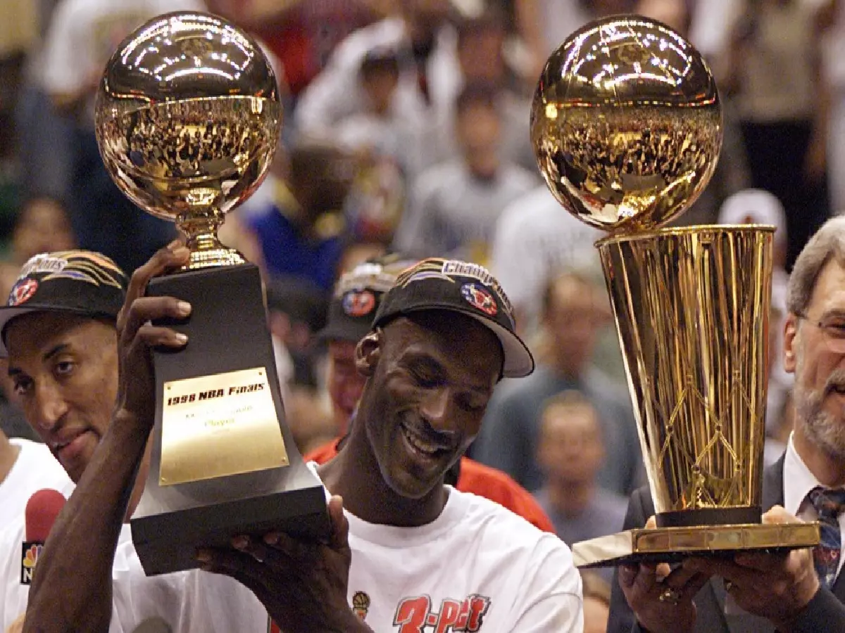 Michael Jordan and coach Phil Jackson celebrate the Chicago Bulls' 1998 NBA Finals victory
