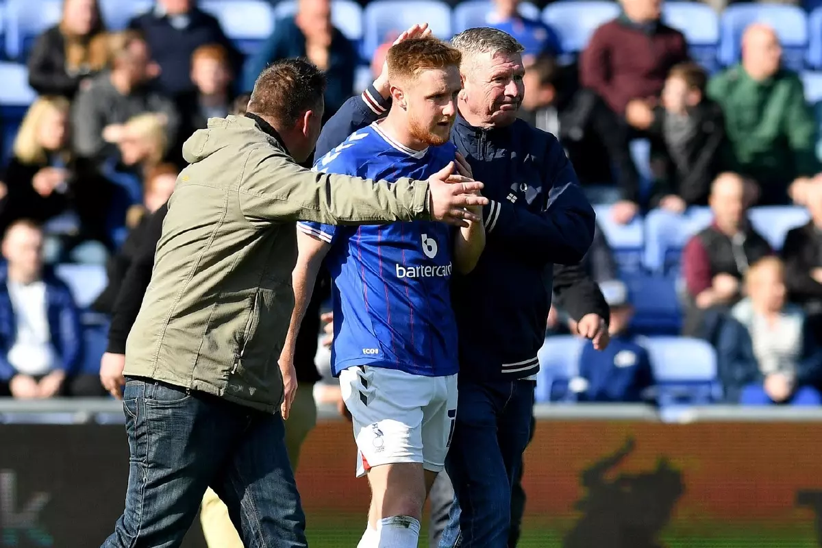 Oldham's Davis Keillor-Dunn leaves the pitch after relegation out of the EFL in April 2022