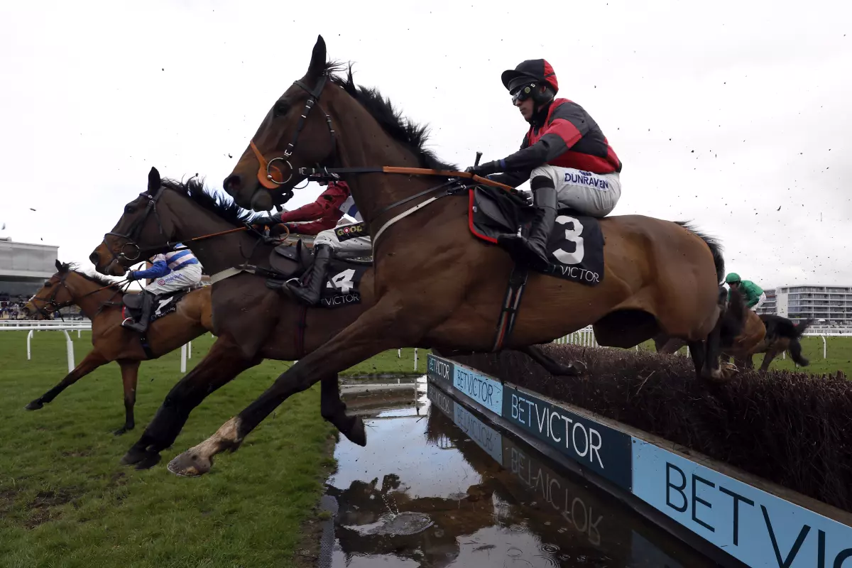 Paint The Dream ridden by jockey Connor Brace clear a fence on their way to winning the BetVictor Greatwood Gold Cup Handicap Chase at Newbury Racecourse, Berkshire.