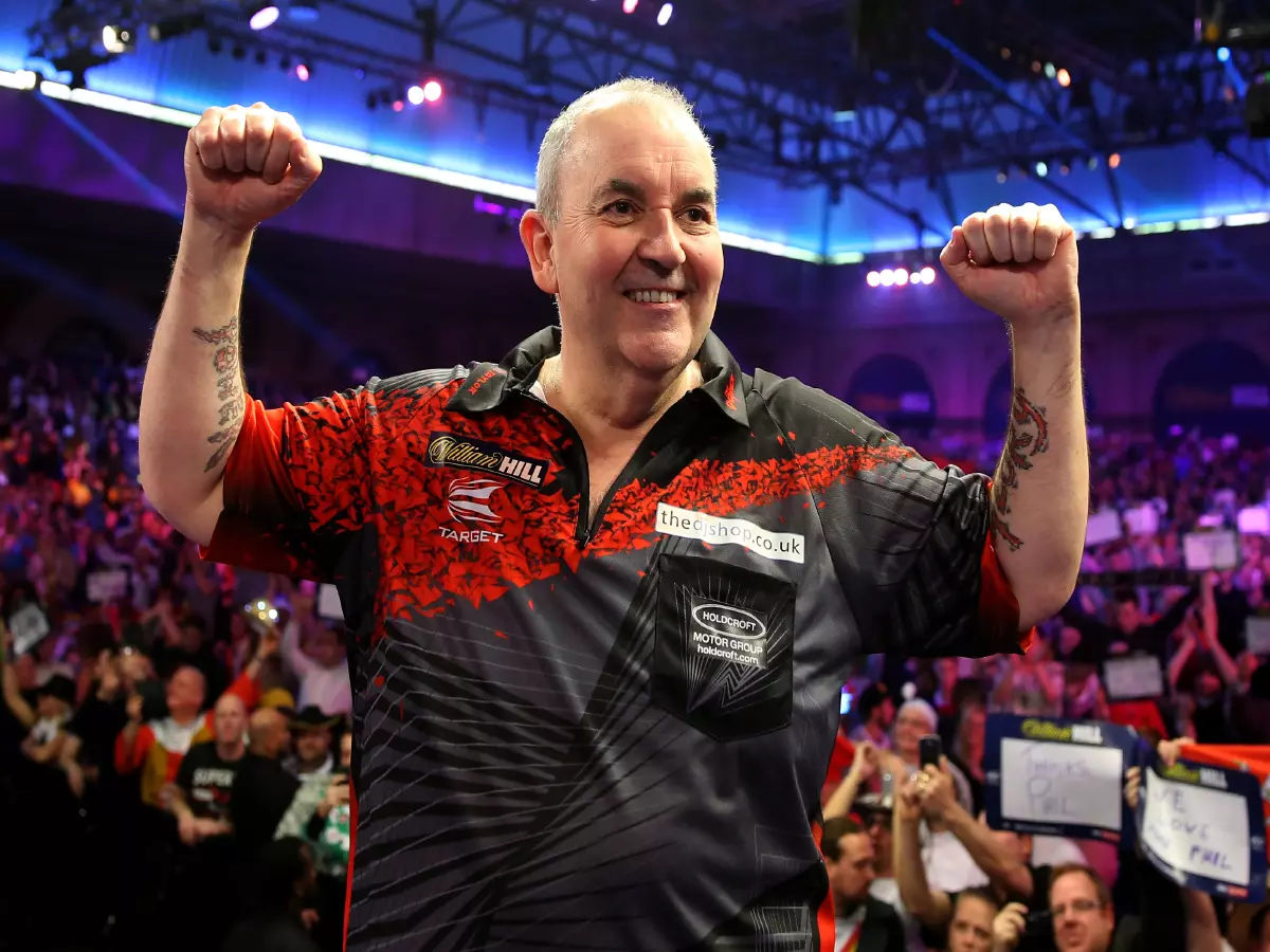 Phil Taylor reacting to the crowd after losing in the final as retires during day fifteen of the William Hill World Darts Championship at Alexandra Palace, London.
