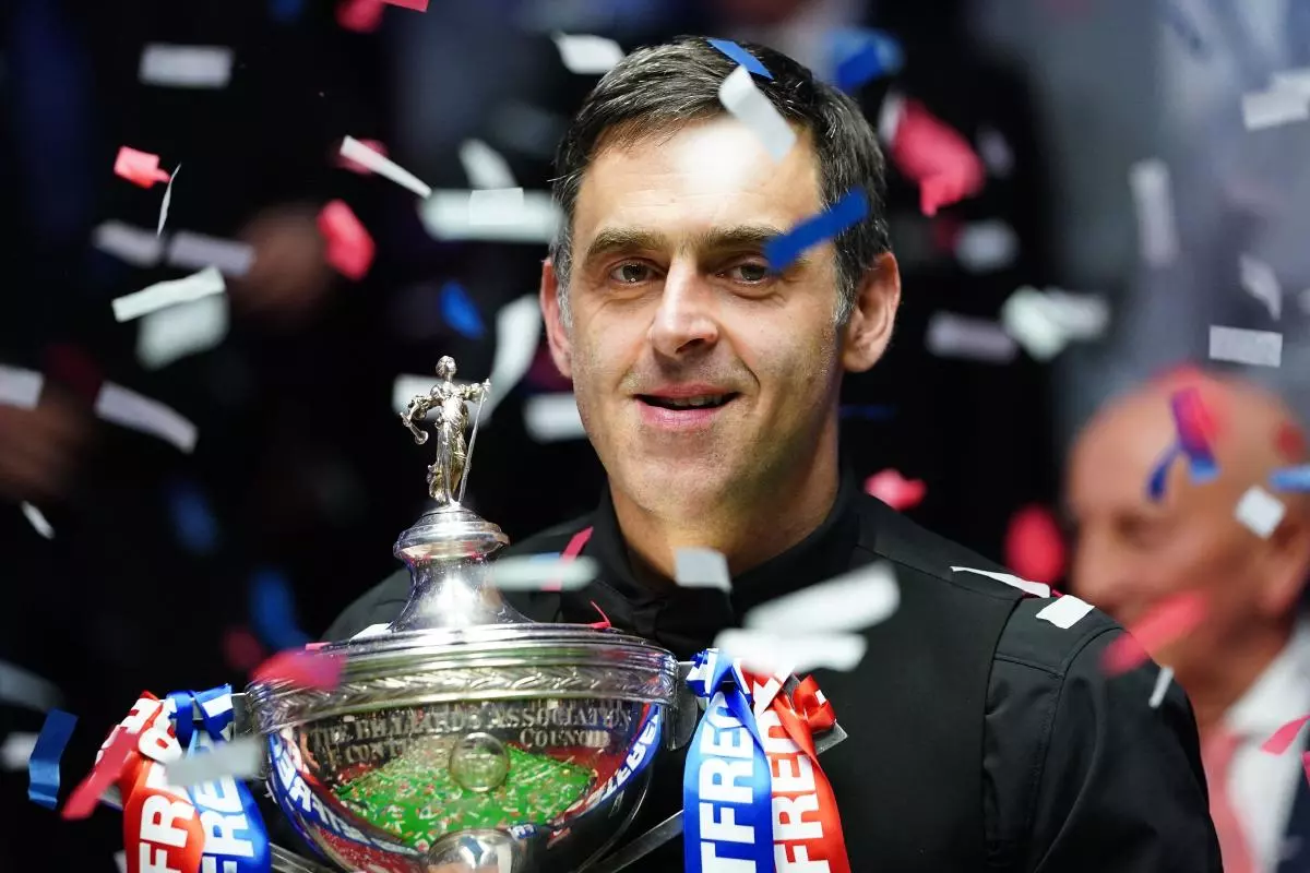 Ronnie O'Sullivan celebrates with the trophy during day seventeen of the Betfred World Snooker Championship at The Crucible,