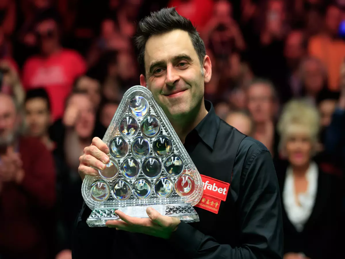 Ronnie O'Sullivan holds the Paul Hunter trophy after his victory during day eight of the Dafabet Masters at Alexandra Palace, London.