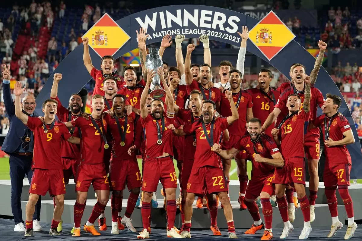Spain players celebrate with the trophy after winning the Nations League final