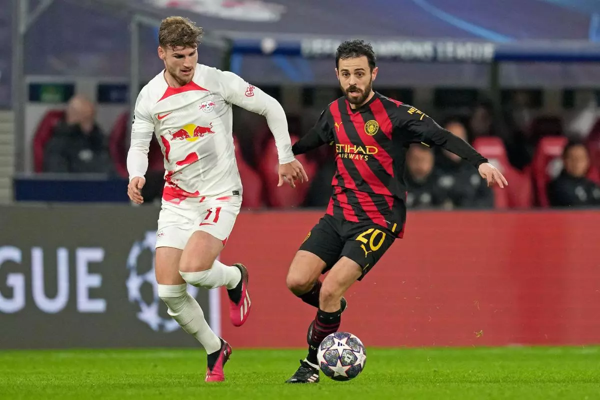 Leipzig's Timo Werner, left, challenges Manchester City's Bernardo Silva