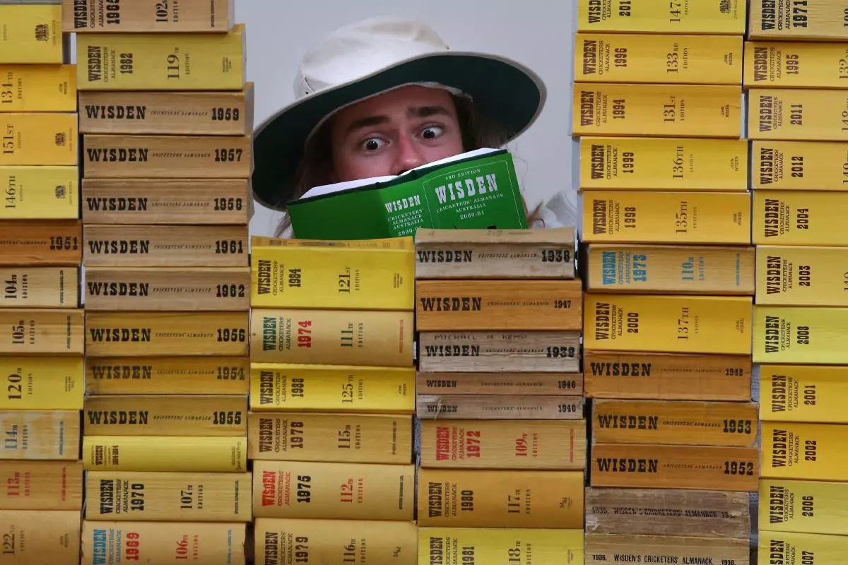 Tommy Alexander from Bonhams, Edinburgh, reads a Wisden Cricketers' Almanack - April 2023