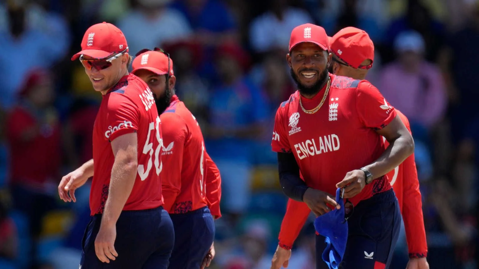 England's Chris Jordan, right, celebrates with teammates after getting a hat-trick by dismissing United States' Saurabh Nethralvakar during the ICC Men's T20 World Cup - June 2023