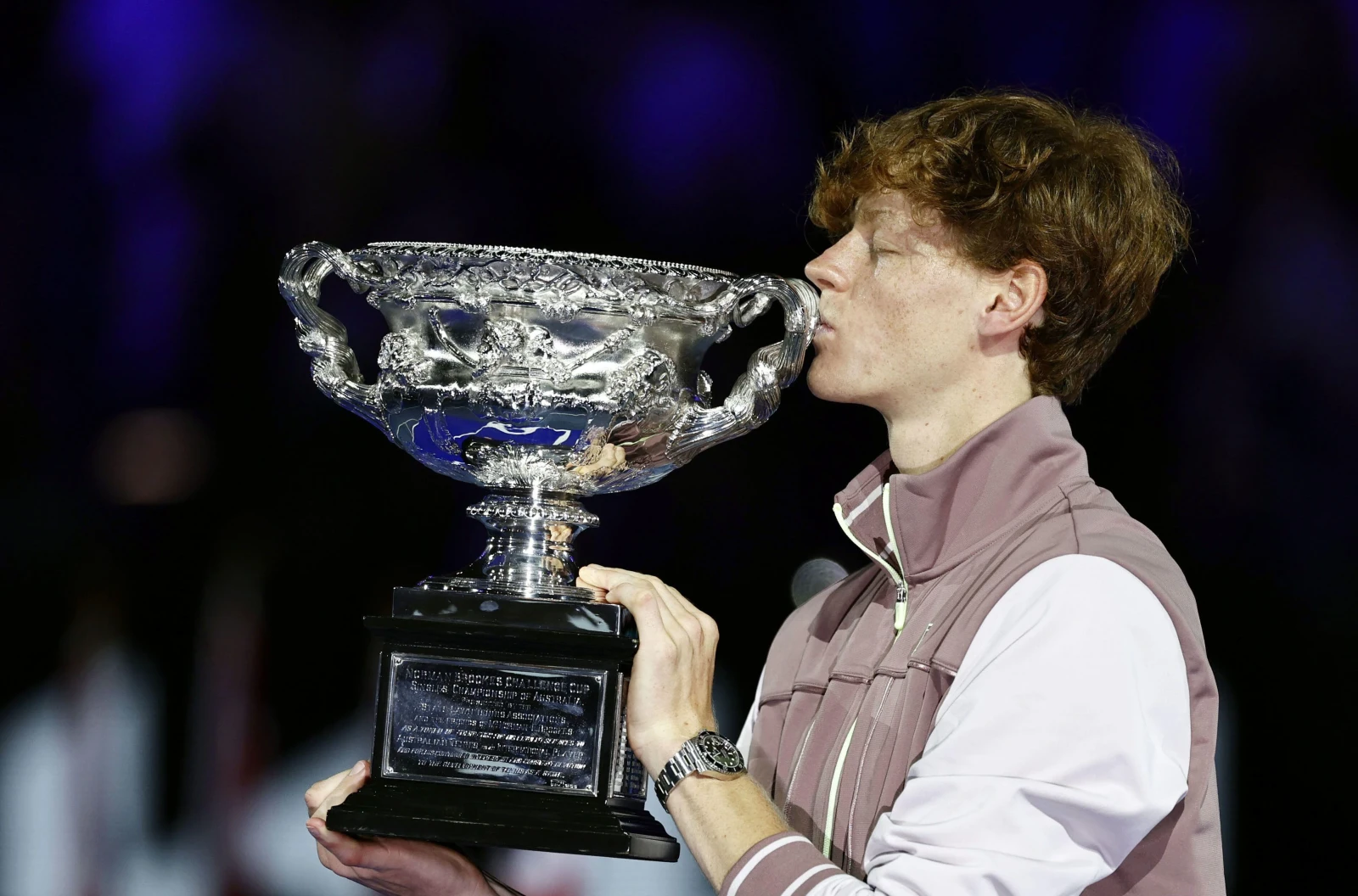 Italy's Jannik Sinner kisses the victor's trophy after winning the men's singles title at the Australian Open