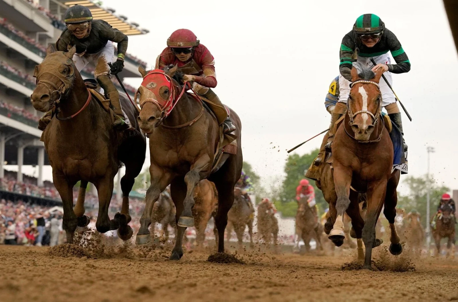 Brian Hernandez Jr. rides Mystik Dan, right, to the finish line to win the 150th running of the Kentucky Derby