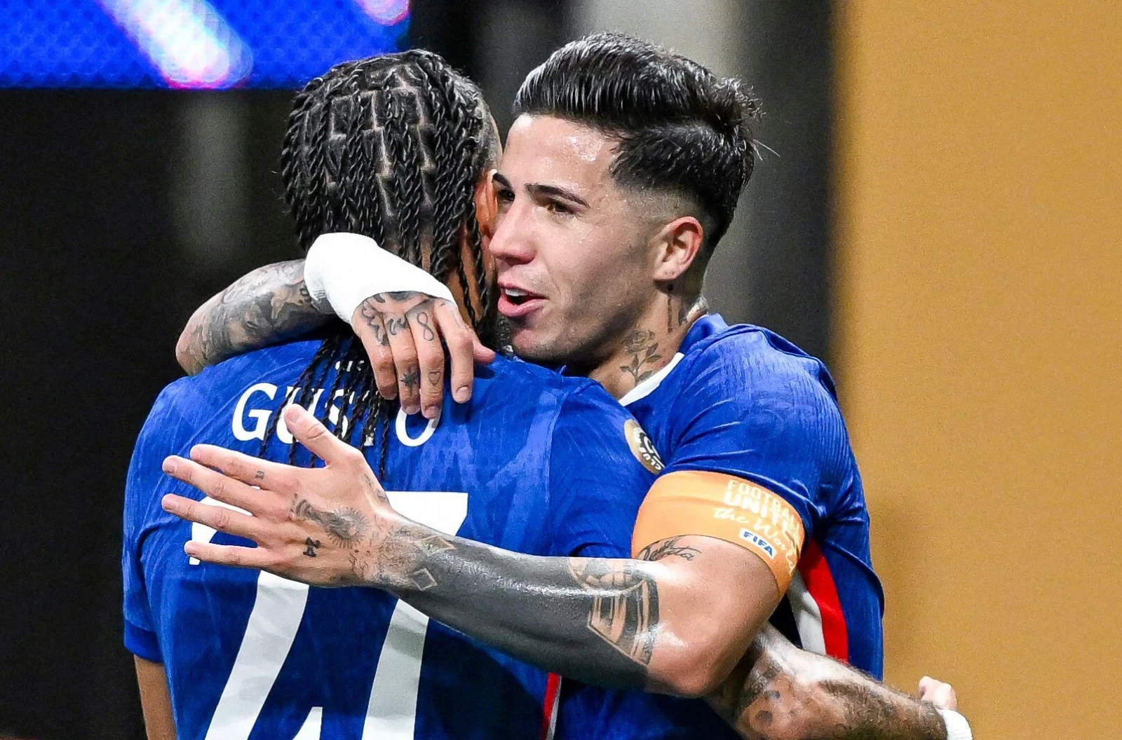 Malo Gusto of Chelsea embraces teammate Enzo Fernandez